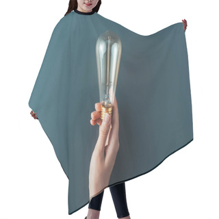 Personality  Cropped Shot Of Person Holding Light Bulb On Grey Background Hair Cutting Cape