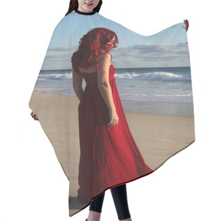 Personality  Full Length Portrait Of  Redhead Woman Wearing Elegant Red Gown. Standing  Pose With Gestural Hands At Sunset Ocean Beach Landscape Background. Hair Cutting Cape