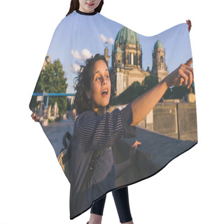 Personality  BERLIN, GERMANY - JULY 14, 2020: Amazed Young Woman Pointing Away Near Blurred Berlin Cathedral Hair Cutting Cape