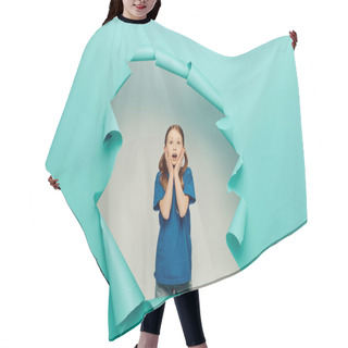 Personality  Scared Redhead Preteen Girl In T-shirt Looking At Camera While Touching Face With Hands Around Blue Torn Paper Hole On White Background, Global Children Day Concept  Hair Cutting Cape