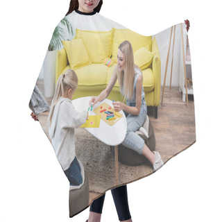 Personality  Positive Woman Holding Plasticine Near Kid At Home  Hair Cutting Cape