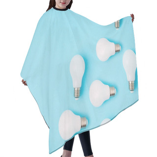 Personality  Flat Lay With Arranged White Light Bulbs Isolated On Blue Hair Cutting Cape