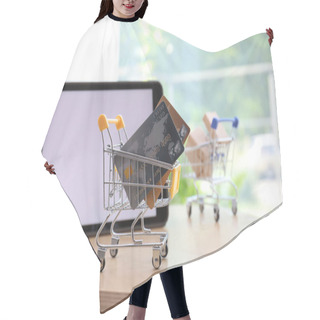 Personality  Internet Shopping. Small Cart With Credit Cards Near Modern Tablet On Table Indoors Hair Cutting Cape