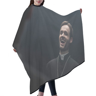 Personality  Young Catholic Priest Laughing Sarcastically While Looking At Own Reflection Isolated On Black Hair Cutting Cape
