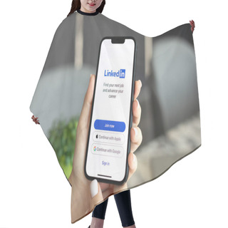 Personality  Alanya, Turkey - October 24, 2023: Woman Hand Holding IPhone 14 And Macbook Pro 16 With App LinkedIn On The Screen. Hair Cutting Cape