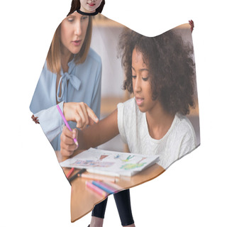 Personality  Psychologist Pointing With Finger At Picture Near African American Girl With Colored Pencil At Coffee Table On Blurred Background Hair Cutting Cape