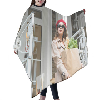 Personality  Young Woman In Trench Coat, Red Beret And Sunglasses Holding Paper Bag With Groceries Near House  Hair Cutting Cape