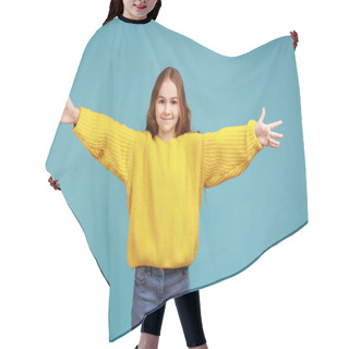 Personality  Portrait Of Happy Cute Little Girl Outstretching Hands To Embrace, Giving Free Hugs And Welcoming, Wearing Yellow Casual Style Sweater. Indoor Studio Shot Isolated On Blue Background. Hair Cutting Cape