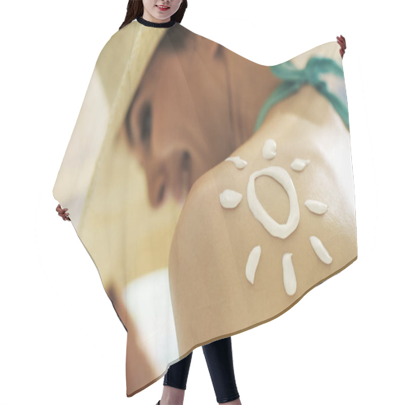 Personality  Woman tanning at the beach with sunscreen cream hair cutting cape