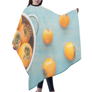 Personality  Selective Focus Of Juicy Orange Persimmons In Colander On Blue Background  Hair Cutting Cape