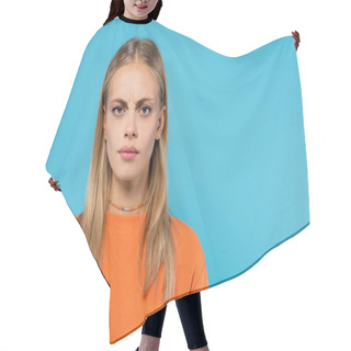 Personality  Offended Blonde Woman In Orange Sweatshirt Looking At Camera Isolated On Blue  Hair Cutting Cape