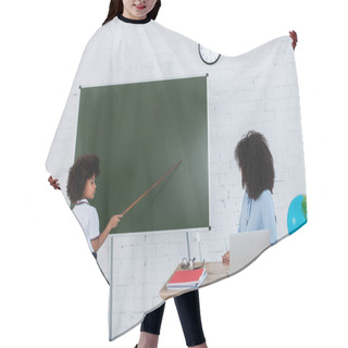 Personality  African American Schoolkid Pointing At Chalkboard Near Teacher And Laptop In Classroom  Hair Cutting Cape