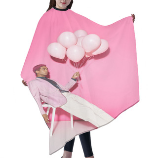 Personality  Handsome Young Male Model Posing Unnaturally With Balloons In Hand On Pink Backdrop, Doll Like Hair Cutting Cape
