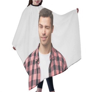 Personality  Close Up Of A Flirting Handsome Attractive Charming Guy Looking Confidently,winks With One Eye, Slightly Smiling, Pleasant Appearance, Dressed In Checkered Shirt, Standing Against White Background. Hair Cutting Cape