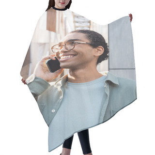Personality  Joyful African American Man In Grey Shirt And Eyeglasses Talking On Smartphone On Urban Street Hair Cutting Cape