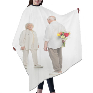 Personality  Elderly Man Hiding Bouquet Of Flowers Behind Back Near Smiling Wife On White Hair Cutting Cape