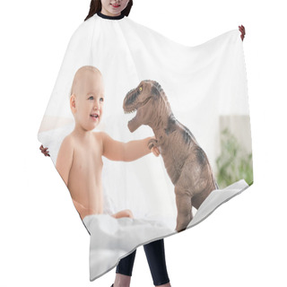 Personality  Cute Little Child Sitting On Bed, Smiling And Holding Brown Toy Dinosaur  Hair Cutting Cape