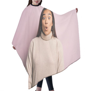 Personality  Young Beautiful Asian Woman Wearing Casual Turtleneck Sweater Over Pink Background Afraid And Shocked With Surprise Expression, Fear And Excited Face. Hair Cutting Cape