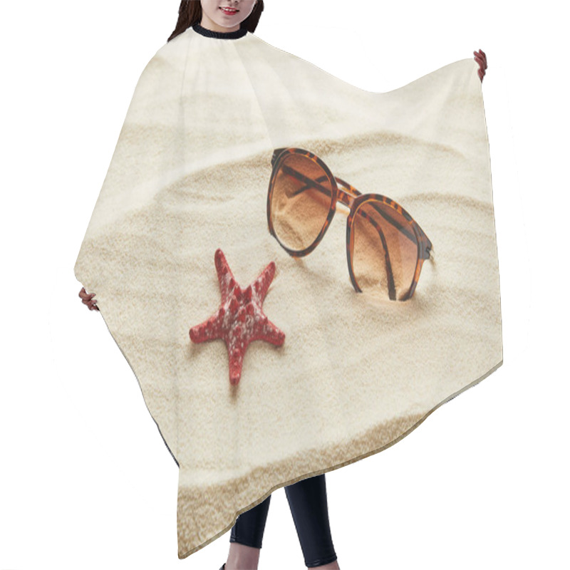Personality  brown stylish sunglasses on sand with red starfish hair cutting cape