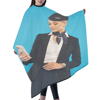 Personality  Young Air Hostess In Elegant Uniform Looking At Mobile Phone While Standing On Blue Background Hair Cutting Cape