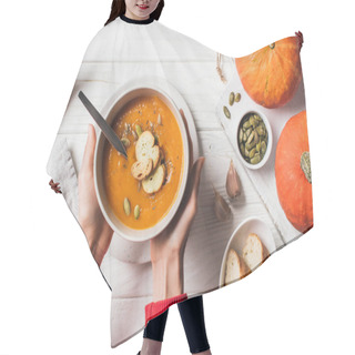 Personality  Cropped Image Of Woman Holding Plate With Homemade Pumpkin Cream Soup With Seeds And Rusks On Table   Hair Cutting Cape