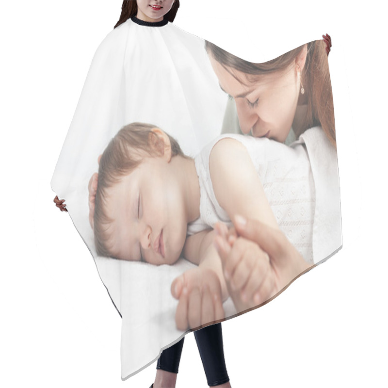 Personality  Mother kissing a baby. Care concept hair cutting cape