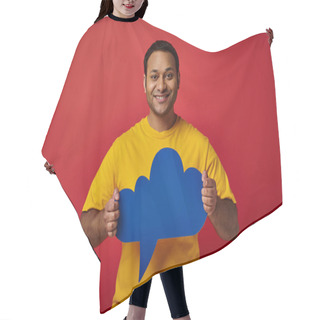 Personality  Cheerful Indian Man In Yellow T-shirt Holding Blue Blank Thought Bubble On Red Backdrop, Happy Face Hair Cutting Cape