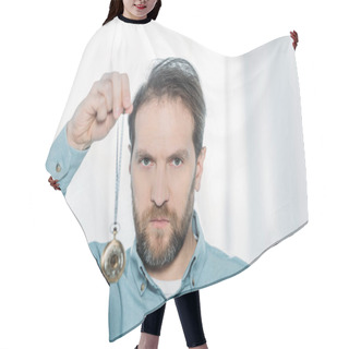 Personality  Serious Bearded Hypnotist Holding Dowsing And Looking At Camera  Hair Cutting Cape