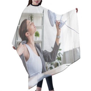 Personality  Selective Focus Of Beautiful Businesswoman Suffering From Heat And Holding Electric Fan Hair Cutting Cape