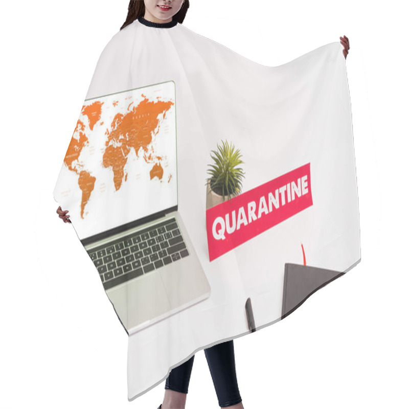 Personality  KYIV, UKRAINE - APRIL 8, 2020: Laptop With World Map On Screen Near Plant, Pen, Notebook And Paper With Quarantine Lettering On White  Hair Cutting Cape