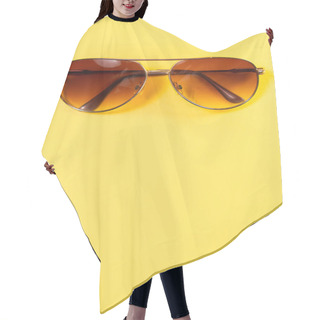 Personality  Close Up Of Aviator Style Sunglasses With Brown Hues Centered At Top Of A Colorful Bright Yellow Background Making A Fantastic Summer Backdrop With Copy Space. Hair Cutting Cape