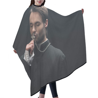 Personality  Young Thoughtful Catholic Priest Kissing Silver Cross With Closed Eyes Isolated On Black Hair Cutting Cape