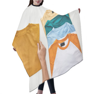 Personality  Cropped View Of Man Holding Ochre T-short Near Beige, Orange, Turquoise And Blue Ones On White Background Hair Cutting Cape