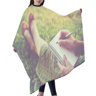 Personality  Female Hands With Pen Writing On Notebook On Grass Outside Hair Cutting Cape