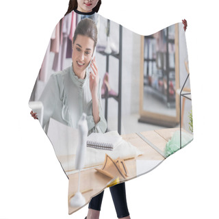 Personality  Smiling Seamstress Talking On Smartphone And Holding Sketch Near Fabric  Hair Cutting Cape