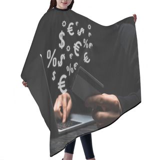 Personality  Selective Focus Of Hacker In Mask Using Laptop While Holding Credit Card Near Money Signs On Black  Hair Cutting Cape