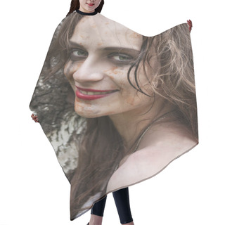 Personality  Beautiful Young Dirty Smiling Mad And Manic Looking Girl Wearing Torn Clothes And Smeared With Mud And Dried Blood Stands And Huddles To A Tree In The Forest. Copy Space. Concept Design. Hair Cutting Cape