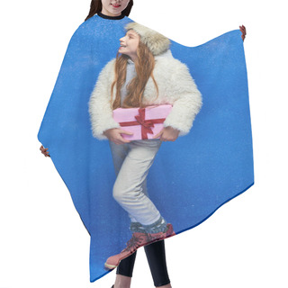 Personality  Winter Joy, Happy Preteen Girl In Faux Fur Jacket And Hat Holding Gift Box On Turquoise Background Hair Cutting Cape