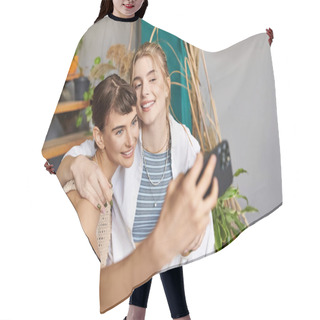 Personality  A Woman Capturing A Selfie With Her Friend In An Art Studio. Hair Cutting Cape
