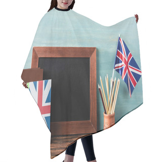 Personality  Empty Chalkboard Near Pencils, Books And Uk Flag On Wooden Table Near Blue Wall Hair Cutting Cape