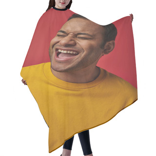 Personality  Face Expression, Excited Indian Man In Yellow T-shirt Laughing On Red Background, Open Mouth Hair Cutting Cape