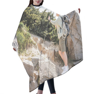 Personality  Side View Of Young Short Haired Woman Tourist With Backpack Holding Trekking Poles Walking On Hill With Stones And Grass At Background, Tranquil Hiker Finding Inner Peace On Trail, Summer Hair Cutting Cape