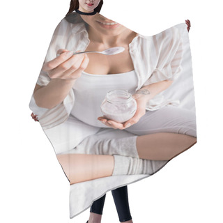 Personality  Cropped View Of Cheerful Pregnant Woman Holding Glass Jar With Yogurt While Sitting On Bed Hair Cutting Cape