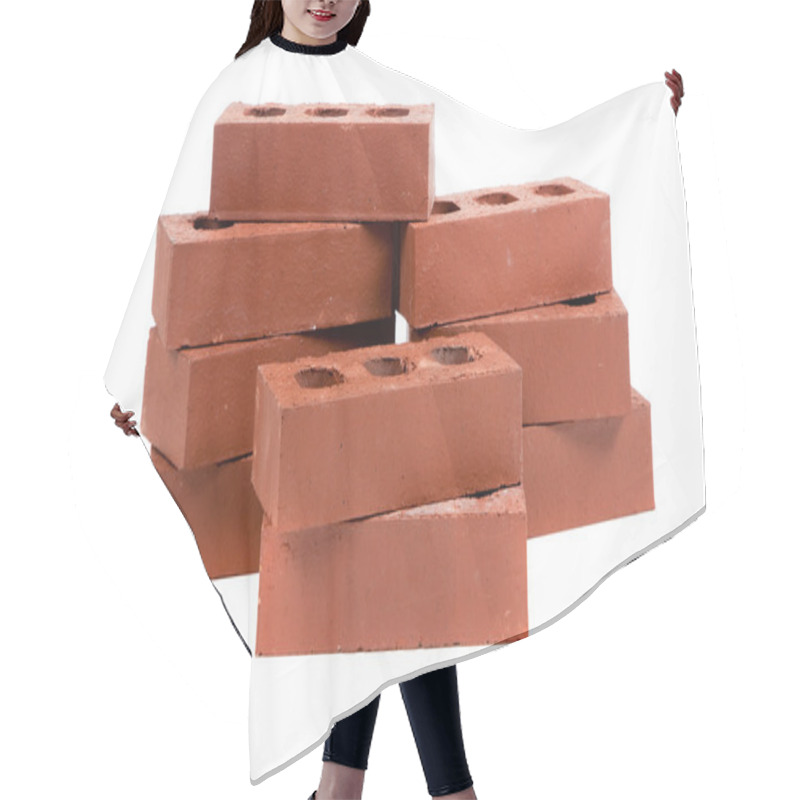 Personality  Stack of red bricks on white hair cutting cape