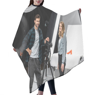 Personality  Happy Young Photographers Standing Near Professional Photo Equipment And Smiling At Camera In Studio  Hair Cutting Cape