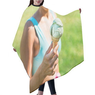 Personality  Ice Cream Cone In Hand Of A Fit Woman In Summer. Gelato And Colorful Fashion In Park. Retro Vibes In Outfit And Icecream On Sunny Weekend. Eating And Enjoying Summertime Vacation Outside. Green Grass. Hair Cutting Cape