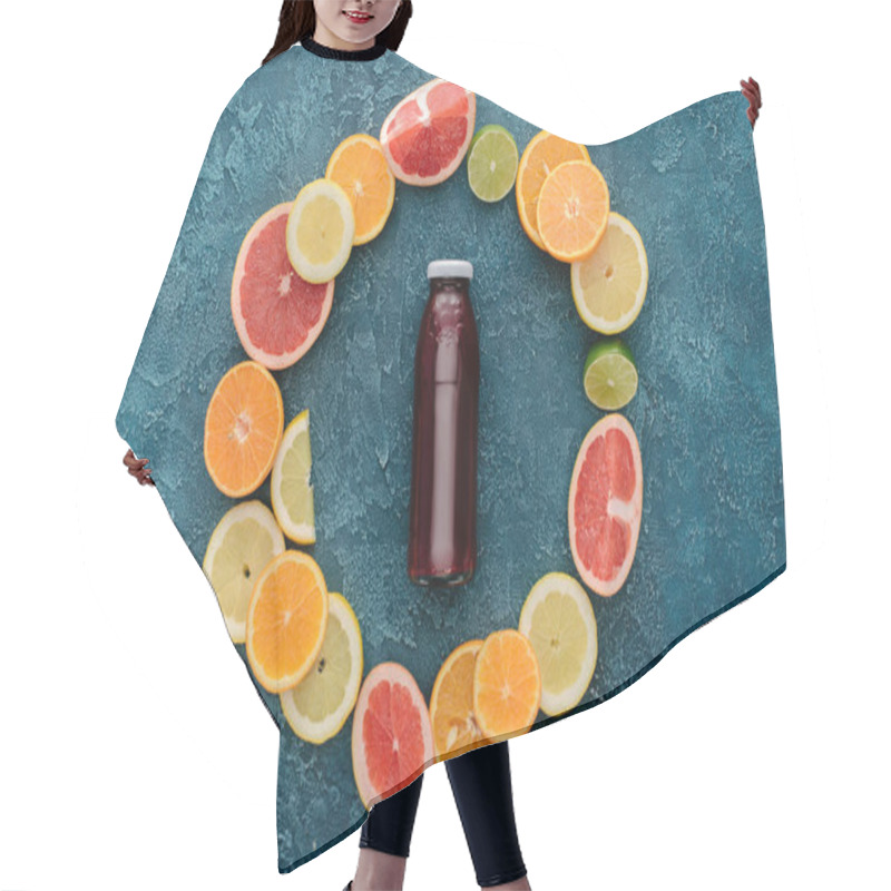 Personality  Top View Of Bottle Of Fresh Juice Surrounded With Citrus Fruits Slices In Circle Shape On Blue Concrete Surface Hair Cutting Cape