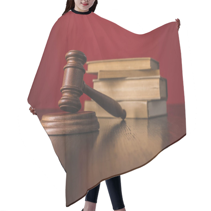 Personality  juridical books with hammer on wooden table, law concept hair cutting cape
