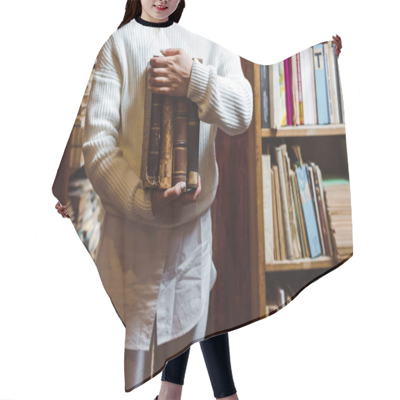 Personality  Partial View Of Woman In White Sweater Holding Books In Library  Hair Cutting Cape
