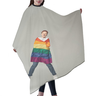 Personality  Overjoyed Queer Person In White T-shirt And Jeans Jumping And Levitating With LGBT Flag On Grey Hair Cutting Cape